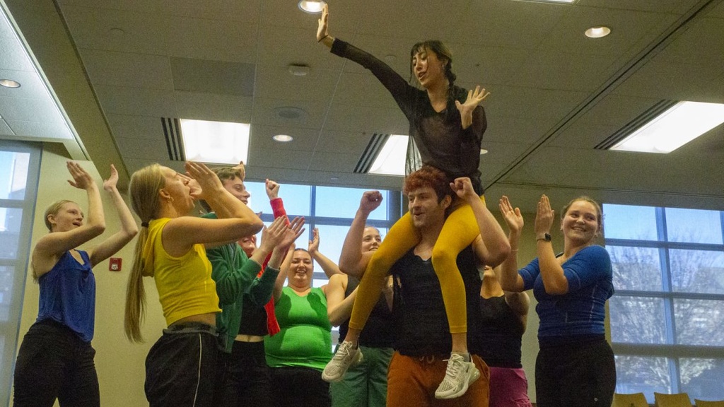 Amelia Fisher is held up by The University of Iowa Dance Company during a performance of “Winning” by Artistic Director Stephanie Miracle, an interactive dance for an audience of children at the Iowa City Public Library on Friday, Nov. 17, 2023