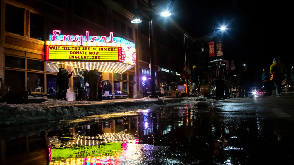 The Englert Theatre sign reflecting in a puddle on the street