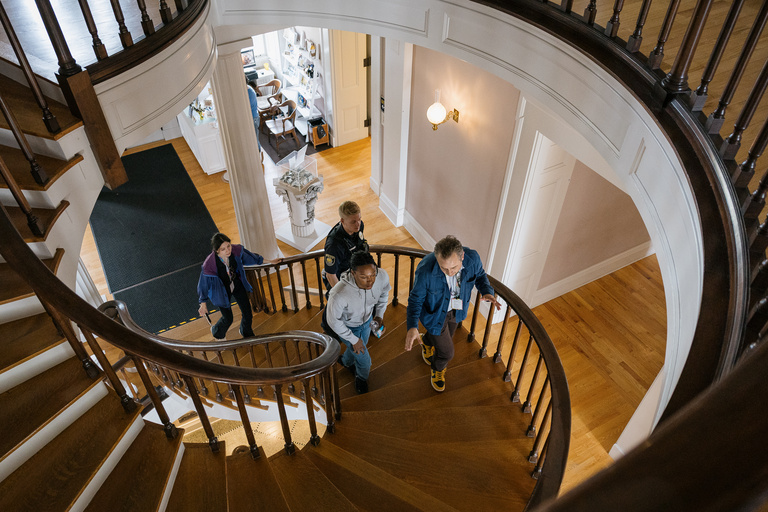 Comedian Josh Johnson ascends the stairs inside the Old Capitol Museum 