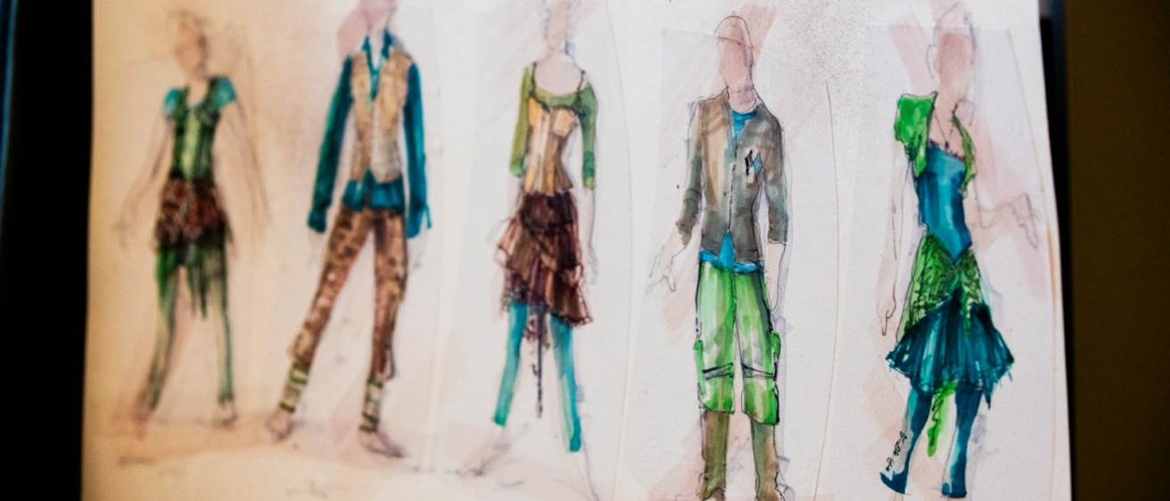 costume sketches seen hanging in costume shop